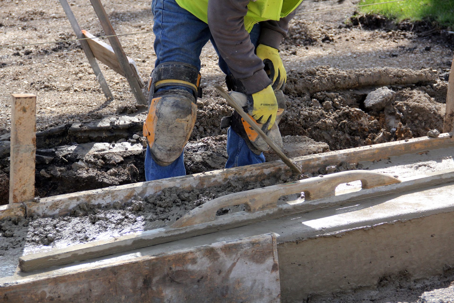 Worker forming and floating a concrete driveway edge in Spartanburg, SC