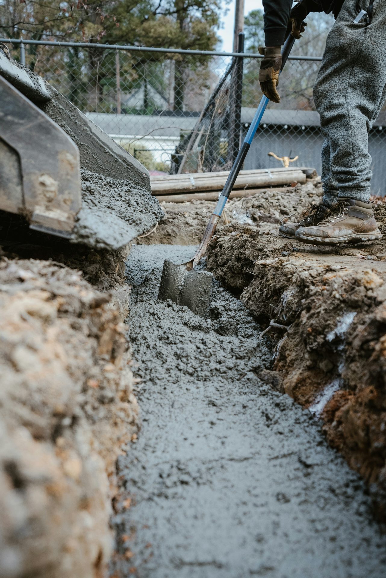 Worker installing a concrete footing on a residential project near Spartanburg, SC