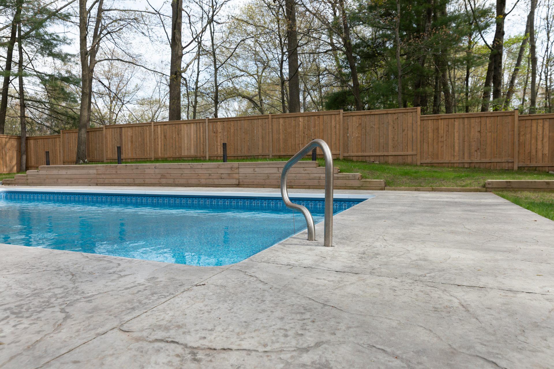 Concrete pool deck patio in a Spartanburg, SC area backyard