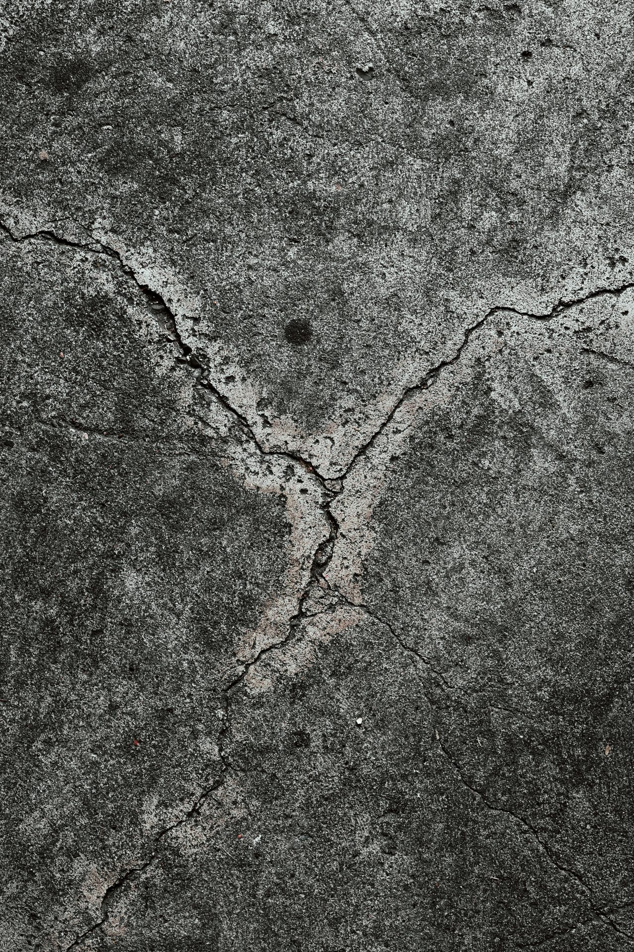 Close-up of cracked concrete surface typical of clay-soil movement in the Spartanburg, SC area